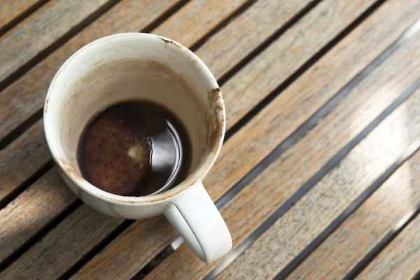 Cup of hot chocolate have been drinking and left on wooden table — Stock Photo, Image
