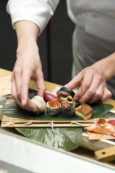Hand arrange sushi for serving — Stock Photo, Image