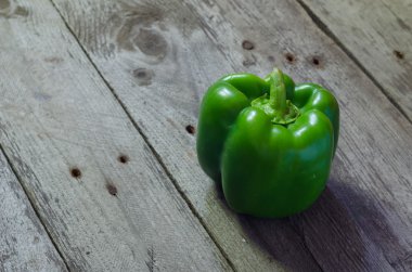 Gri ahşap zemin üzerine yeşil kırmızı biber