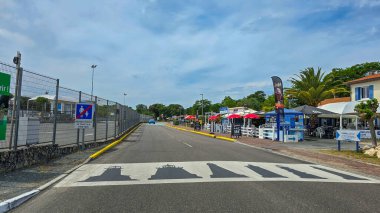 The crosswalk with pictures of different Lighthouses. Original design solutions. In the background is a many restaurants and green trees. June 04, 2025. Verdon-sur-Mer, France.