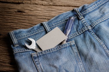 Several tools on a denim workers pocket clipart