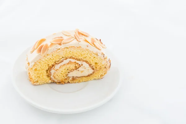 Almond roll cake on white dish — Stock Photo, Image