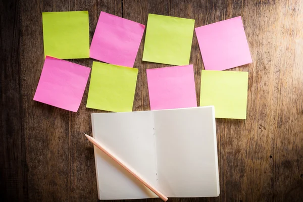Eight blank colorful sticky notes and notebook and pencil — Stock Photo, Image