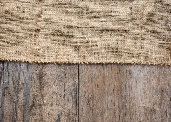 Jute en houten textuur achtergrond — Stockfoto