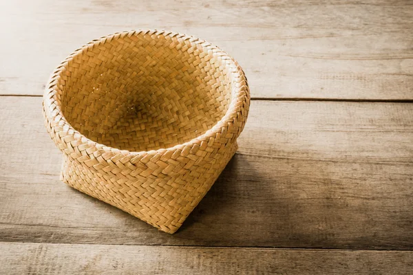 Empty wicker basket on wooden background — Stock Photo, Image