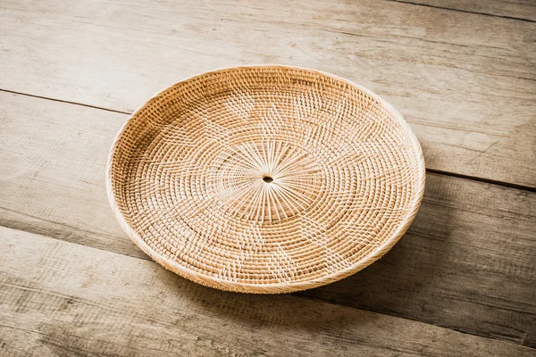 Wicker placemat on wooden table — Stock Photo, Image