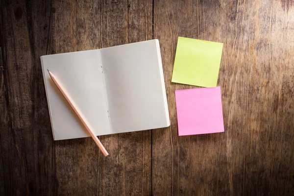 Two blank colorful sticky notes and notebook and pencil — Stock Photo, Image