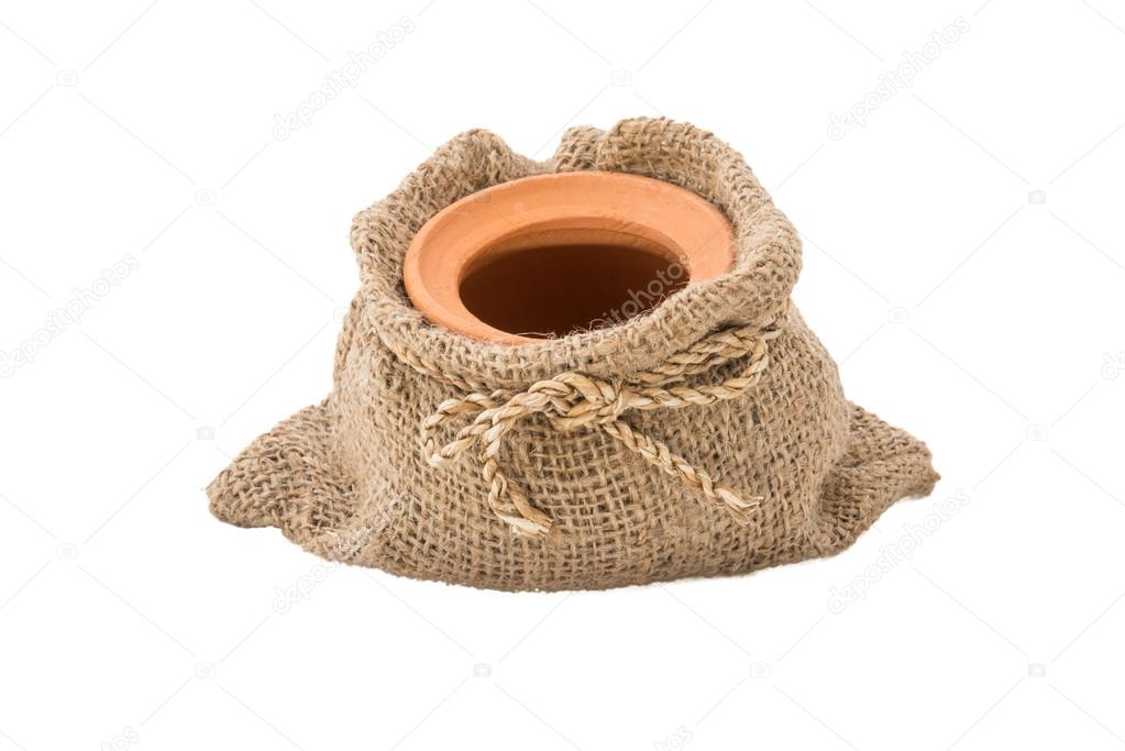 Clay pot in sackcloth bags isolated