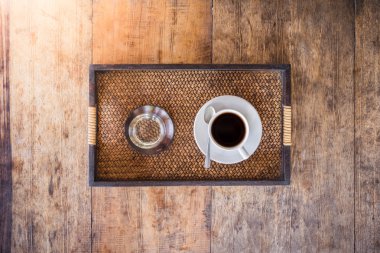 Cup of coffee on a wooden table clipart