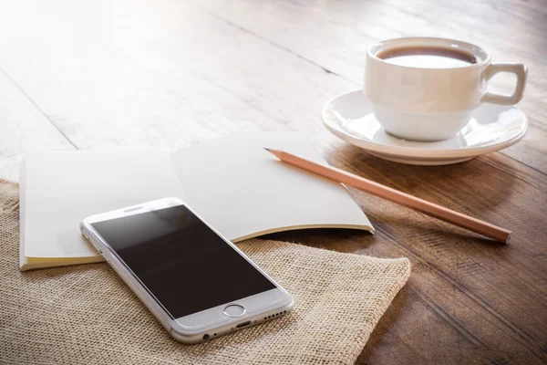 Cup of coffee on a wooden table — Stock Photo, Image