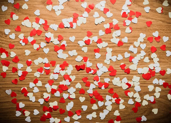 Many red and white heart on a wooden background — Stock Photo, Image