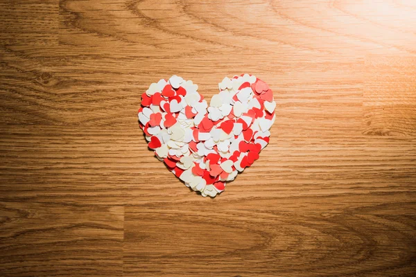 Many red and white heart on a wooden background — Stock Photo, Image