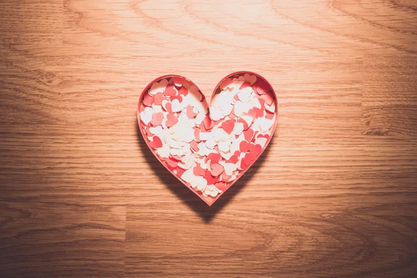 Many red and white heart on a wooden background — Stock Photo, Image