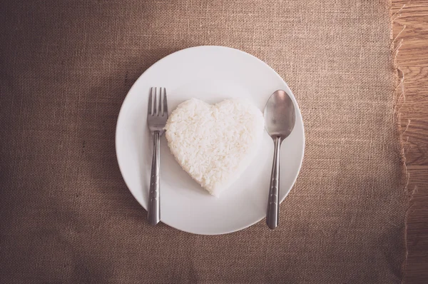 Rice heart shape on whiteplate — Stock Photo, Image