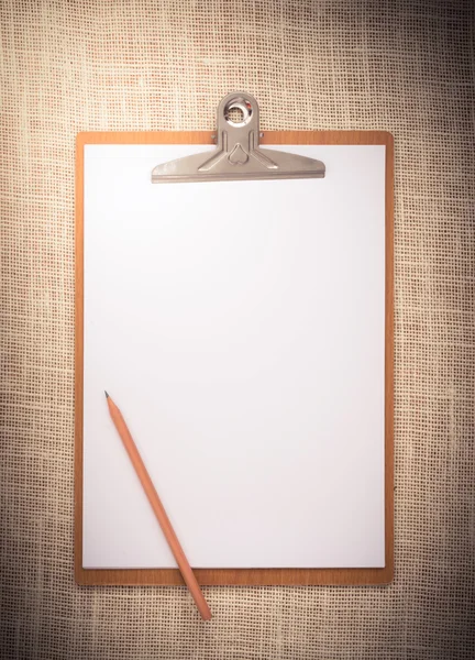 Wooden clipboard on a old sackcloth background — Stock Photo, Image