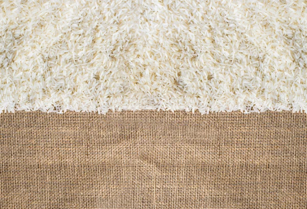 Rice on sackcloth use for background — Stock Photo, Image