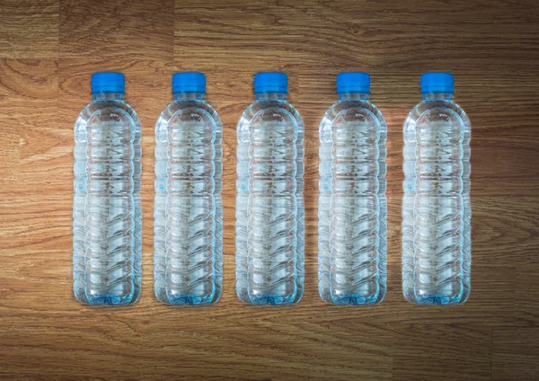 Plastic water bottle on the wooden table — Stock Photo, Image