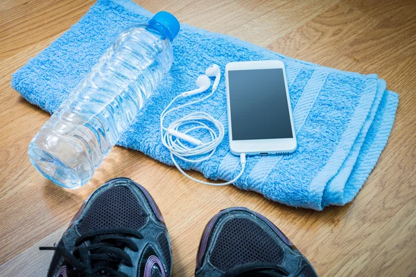 Sport equipment. Sneakers, water , earphones, smart phone — Stock Photo, Image