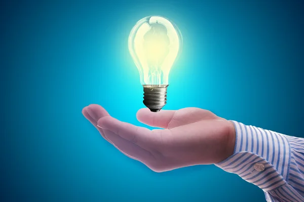 Light bulb on hand businessman — Stock Photo, Image