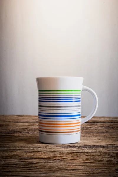 White mug on wooden tabletop — Stock Photo, Image