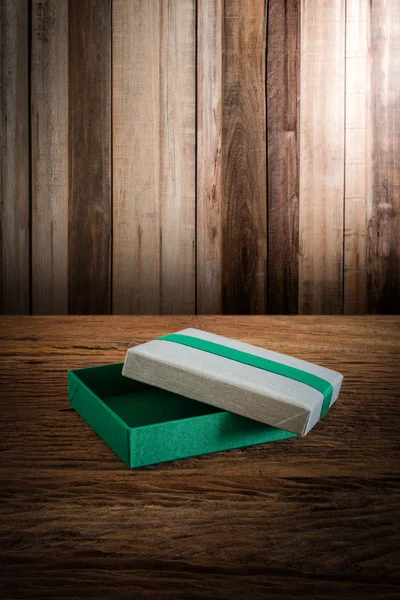 Fabric Box on wooden tabletop against grunge wall — Stock Photo, Image