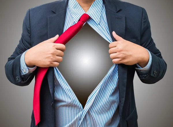Businessman showing a superhero suit underneath his suit, isolat — Stock Photo, Image