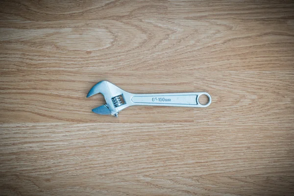 Wrench on wooden background — Stock Photo, Image