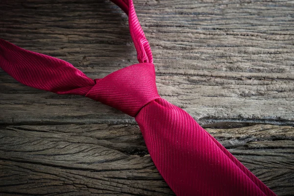 Red necktie on wooden table — Stock Photo, Image