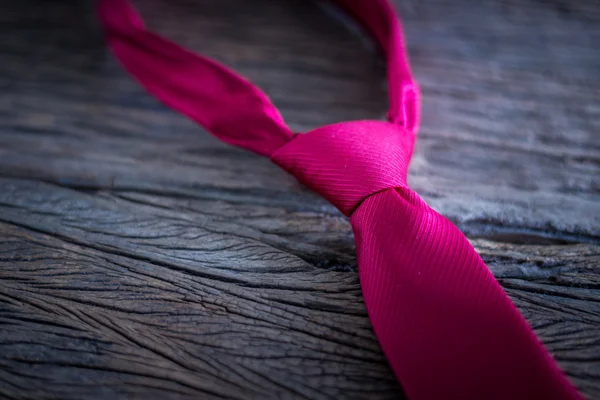 Red necktie on wooden table — Stock Photo, Image