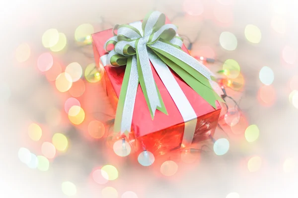 Christmas gift boxes with light on wood — Stock Photo, Image