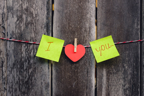 Red paper heart-shaped and words of love