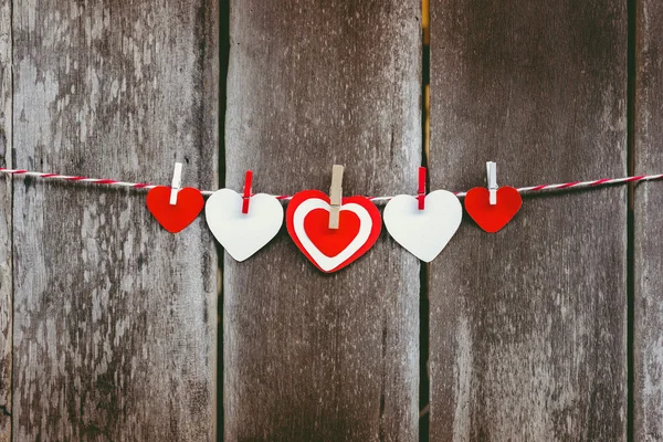 Red paper heart hanging on the clothesline — Stock Photo, Image