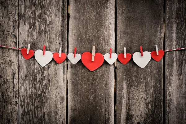 Red paper heart hanging on the clothesline — Stock Photo, Image
