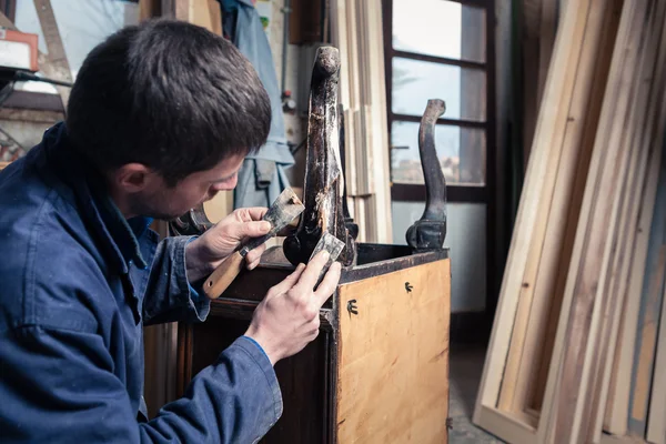 Carpintero restaurando muebles de madera con yeso y masilla Knif — Foto de Stock