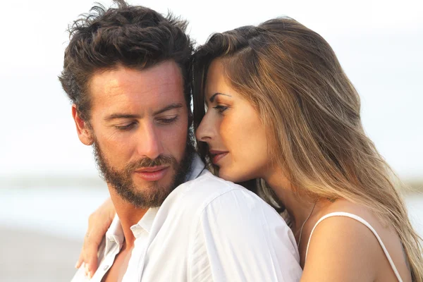 Woman embracing her man from behind on seaside background — Stock Photo, Image