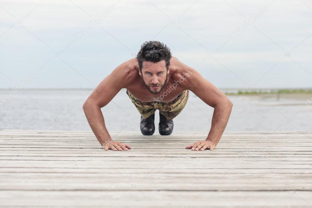 Athletic Army Doing Push Up Exercise at the Beach