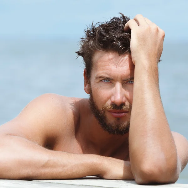 Handsome Man with No Shirt Posing at the Sea Stock Picture