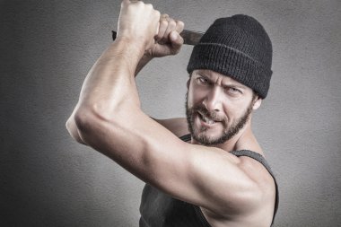 Violent man using a spanner or wrench as a weapon  clipart