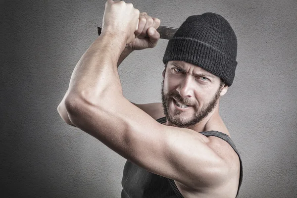 Violent man using a spanner or wrench as a weapon — Stock Photo, Image