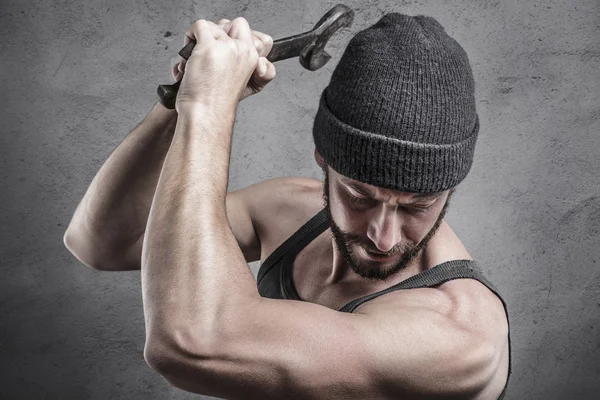 Violent man using a spanner as a weapon — Stock Photo, Image