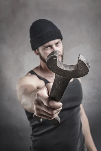 Aggressive man using a wrench as a weapon — Stock Photo, Image