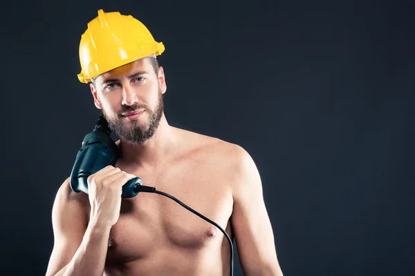 Porträt eines attraktiven, hemdlosen Arbeiters mit Bohrer — Stockfoto