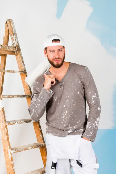 Smiling handsome painter with paint brush — Stock Photo, Image