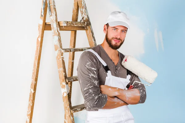 Smiling handsome painter with paint brush — Stock Photo, Image