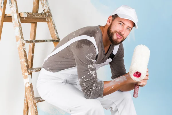 Smiling handsome painter with paint brush — Stock Photo, Image