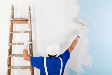 painter painting a wall with paint roller clipart