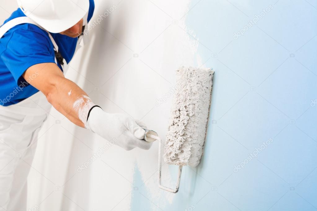 painter painting a wall with paint roller