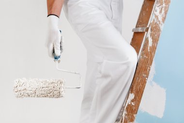 painter with paint roller on ladder clipart
