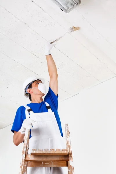 Painter painting ceiling with brush — Stock Photo, Image