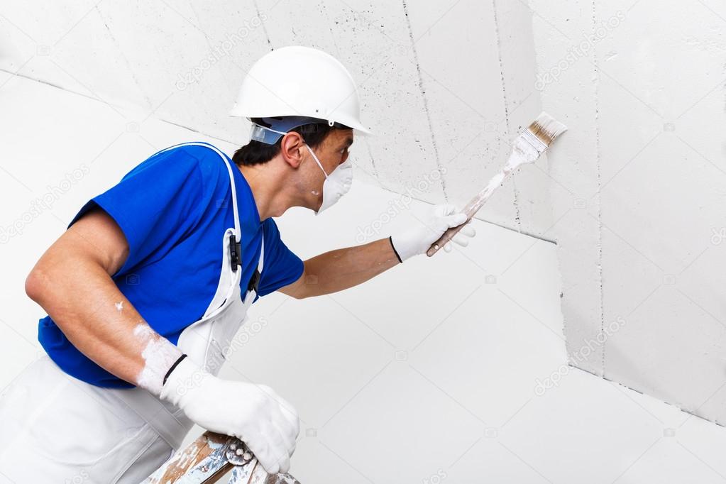 Painter Painting Ceiling With Brush Stock Photo